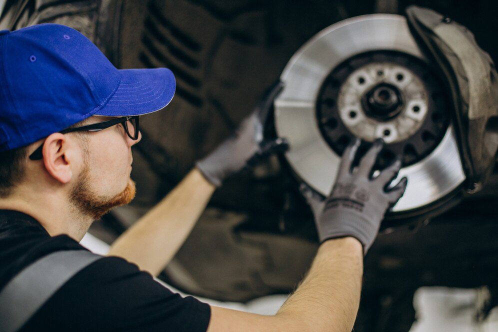 Mechanic changing brake discs in car service<br />